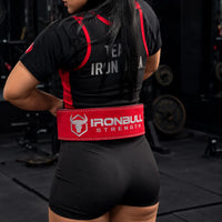 #color_pink | Lifter wearing Iron Bull Strength double prong lifting belt during a workout